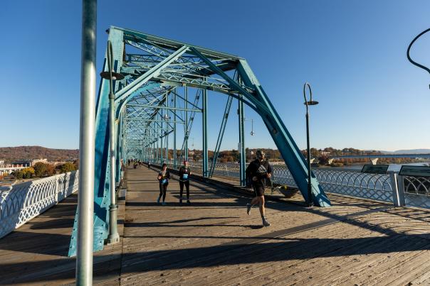 Marathon participants running on Walnut Street Pedestrian Bridge.