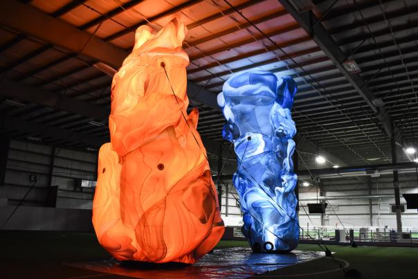 Rising Action - Large blue and red art inflatables lit up