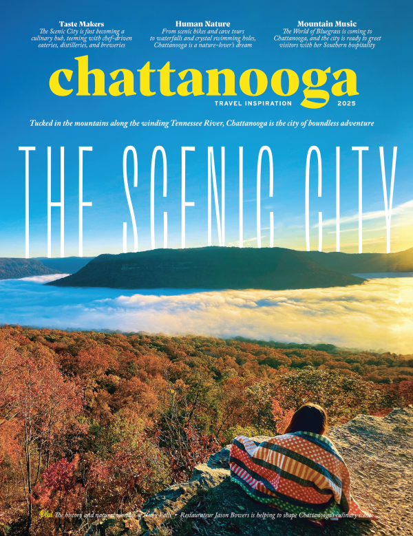 The Scenic City | Chattanooga Travel Inspiration Magazine 2025 | Magazine cover shows person sitting on mountain edge with view of sunrise, cloud inversion and another mountain beyond